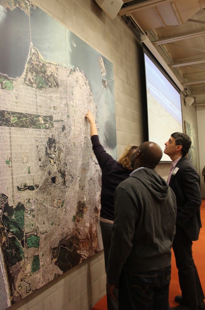 Greg Love, Rose Fellowship coordinator for Memphis (foreground); Geraldene Moyle, Rose Fellowship coordinator for Portland; and Reid Dulburger (right), Chief Economic Development Office of Memphis and Shelby County, Tenn., investigate a map of San Francisco at SPURS’ office.