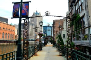 Decorative Enhancements The RiverWalk System is three-miles long, making continuous activation difficult. Along the stretches that lack retail and/or restaurant activity, the system is enhanced with banners, floral baskets, benches and decorative trellises to provide elements of interest. Photo Credit – Dennis Raschke, The Milwaukee RiverWalk District, Inc.
